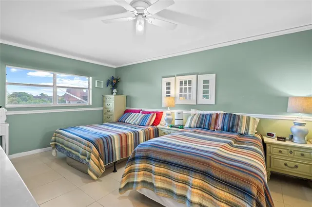 a bedroom with two beds and a window