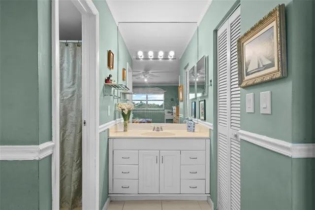 a bathroom with a sink a mirror and a shower