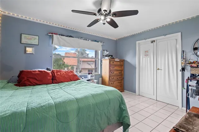 a bedroom with a large bed and a chandelier
