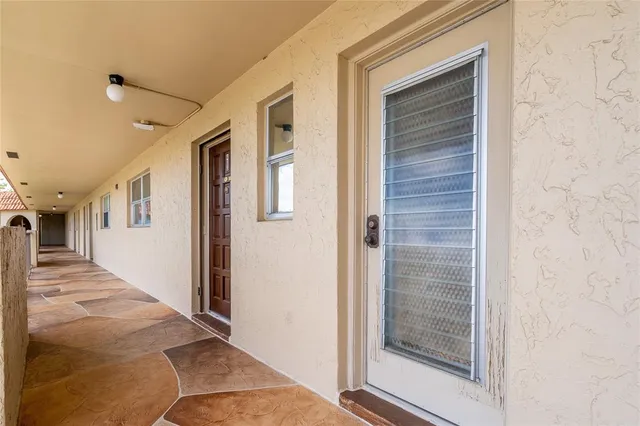 a view of a hallway with wooden floor and entryway