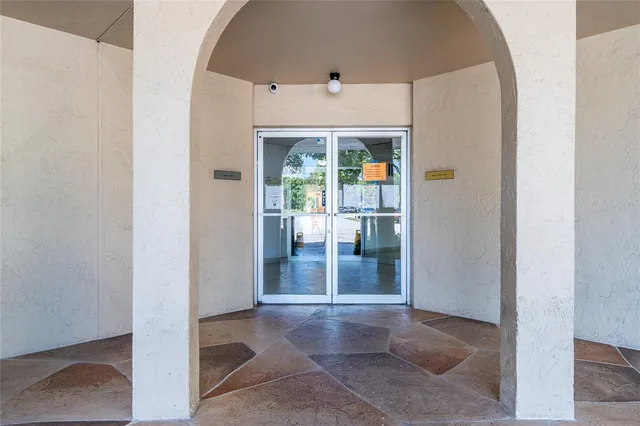 a view of a chair and table in backyard of house
