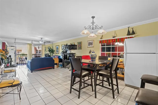 a view of a dining room with furniture and a chandelier