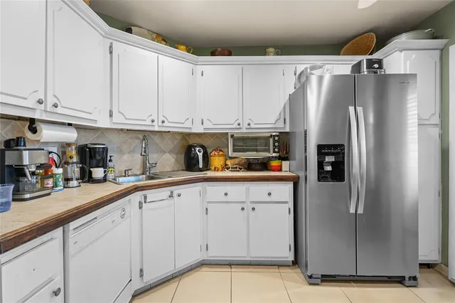 a kitchen with stainless steel appliances granite countertop a refrigerator sink and cabinets