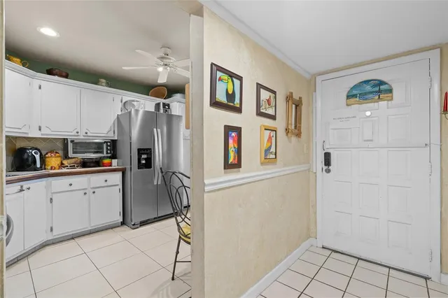 a kitchen with stainless steel appliances a refrigerator and a stove top oven