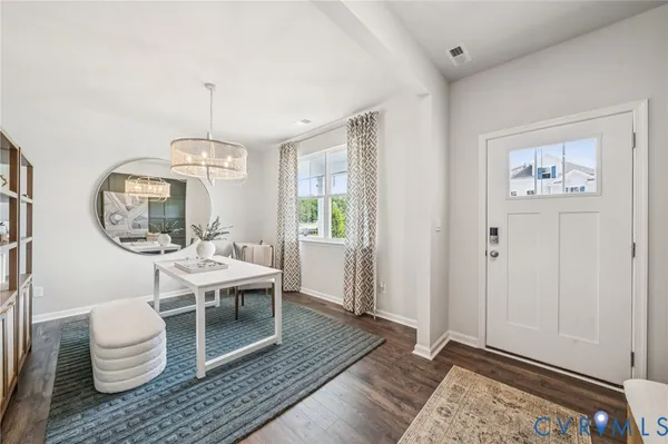 a living room with a couch and chandelier
