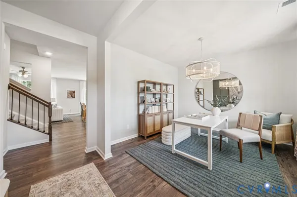 a living room with furniture a wooden floor and next to a window