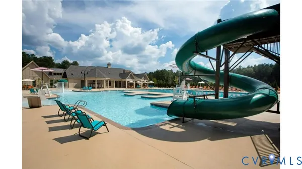 an aerial view of a house with backyard swimming pool and outdoor seating
