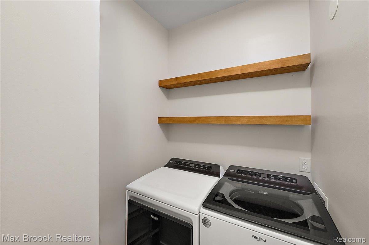 4597 Clarkston Road Clarkston, MI 48348 - Photo 58 of 74 Built-in wood-finish shelving above laundry appliances