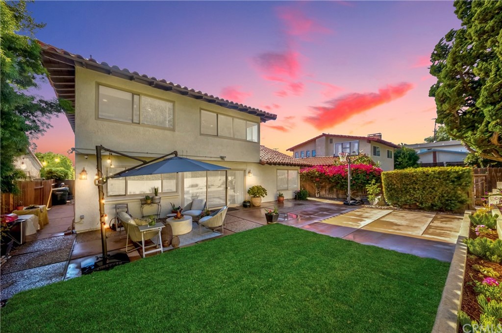 29008 Warnick Road Rancho Palos Verdes, CA 90275 - Photo 1 of 1 a view of a yard with table and chairs under an umbrella