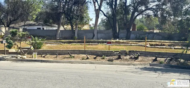 a view of a swimming pool with a yard and trees