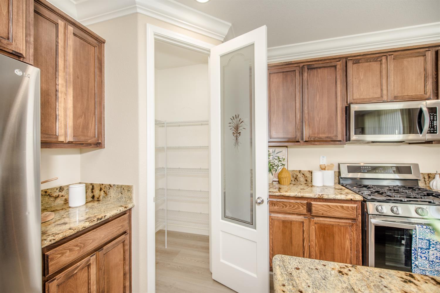 1701 Sandypoint Road West Sacramento, CA 95691 - Photo 11 of 41 a kitchen with stainless steel appliances granite countertop a stove a sink and a microwave