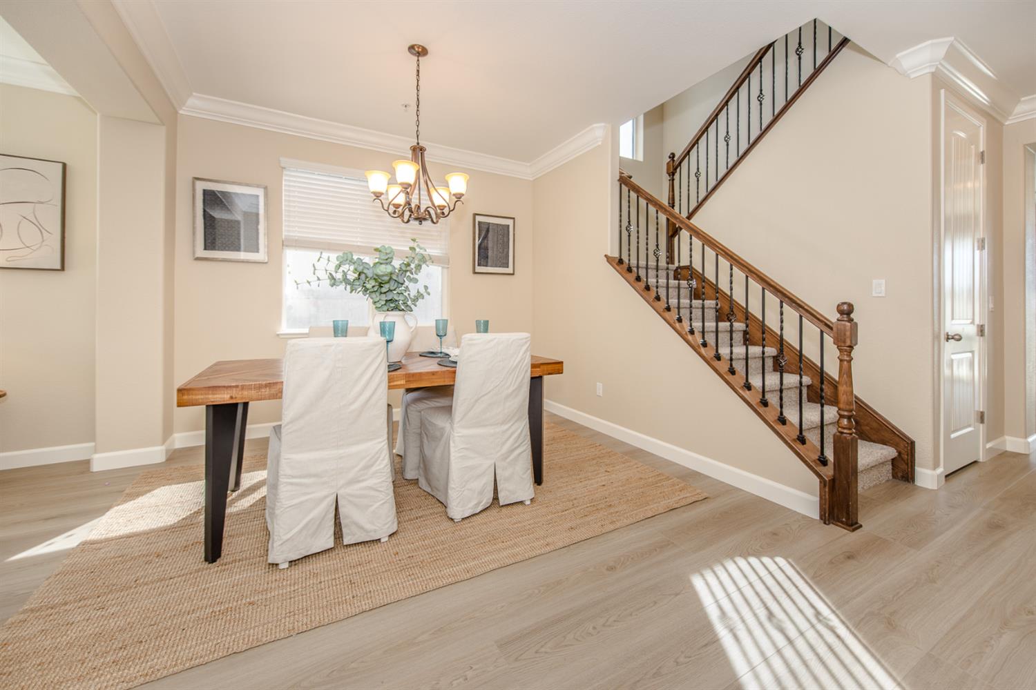 1701 Sandypoint Road West Sacramento, CA 95691 - Photo 5 of 41 a view of a dining room with furniture wooden floor and a chandelier