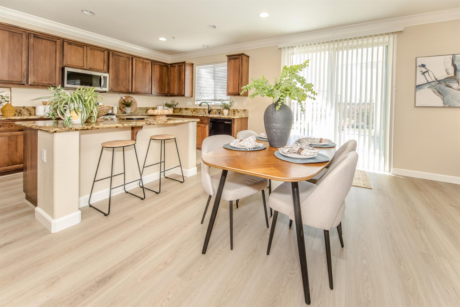 1701 Sandypoint Road West Sacramento, CA 95691 - Photo 6 of 41 a kitchen with stainless steel appliances kitchen island granite countertop a table chairs and a refrigerator