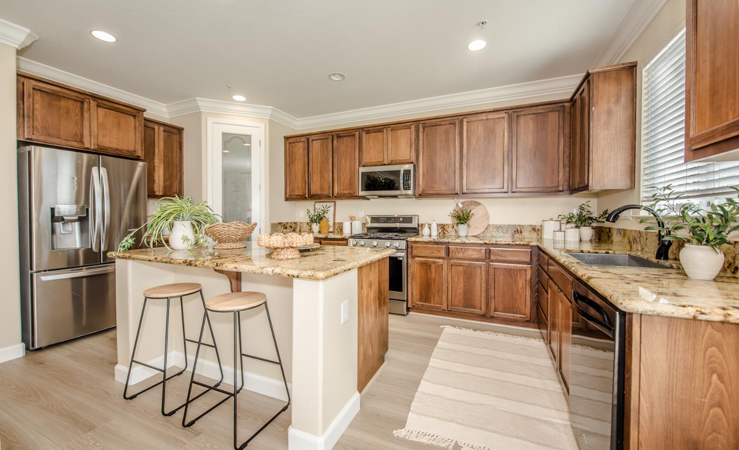 1701 Sandypoint Road West Sacramento, CA 95691 - Photo 8 of 41 a kitchen with stainless steel appliances granite countertop a stove top oven a sink dishwasher a refrigerator and cabinets with wooden floor
