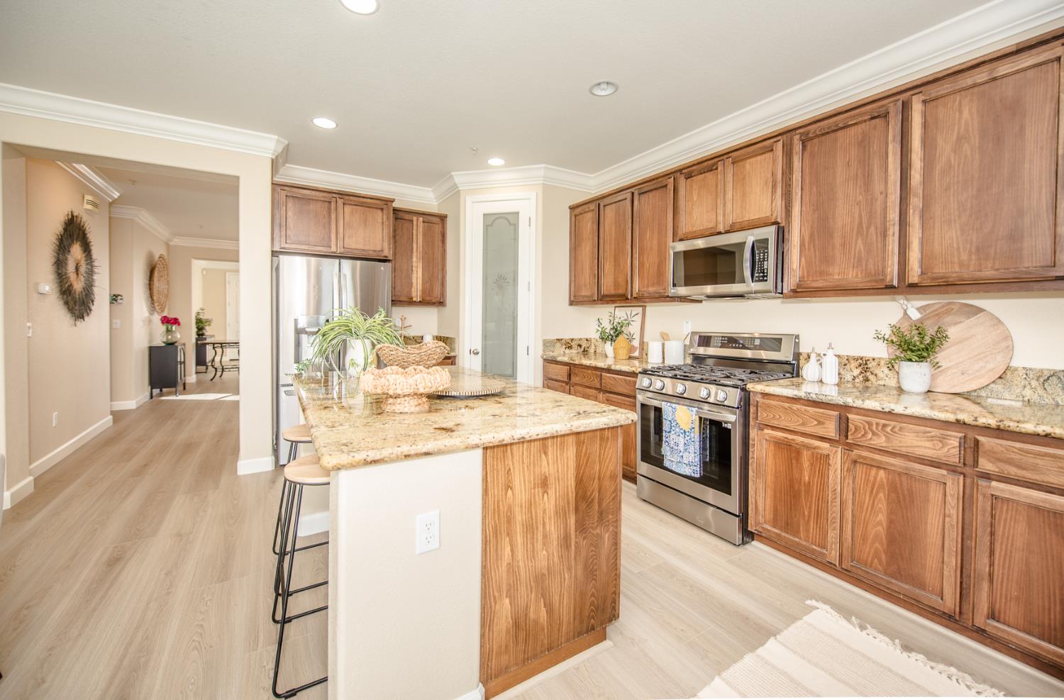 1701 Sandypoint Road West Sacramento, CA 95691 - Photo 9 of 41 a kitchen with stainless steel appliances granite countertop a stove top oven a sink dishwasher and a refrigerator with wooden floor