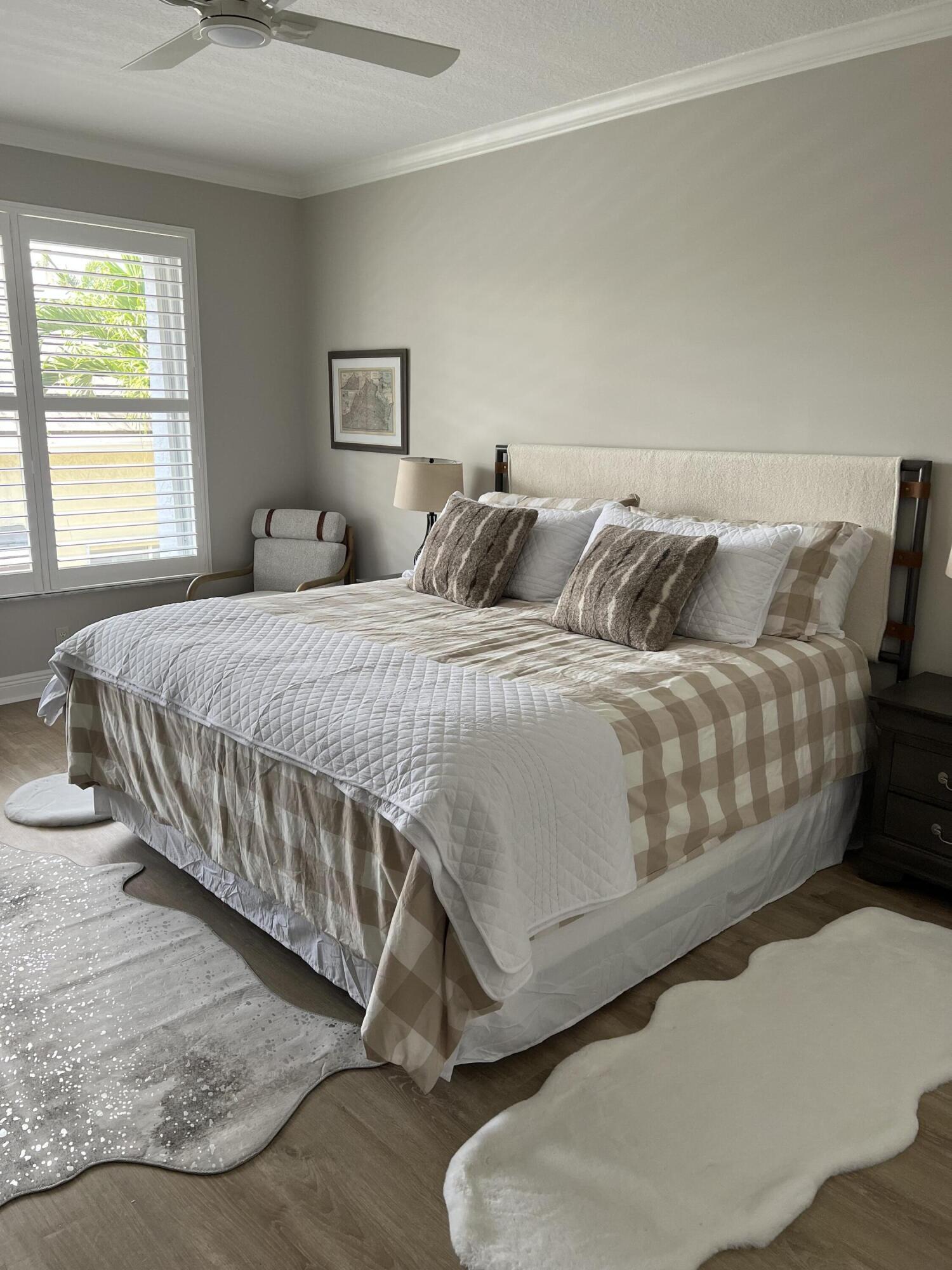 3028 Windward Way Jupiter, FL 33477 - Photo 13 of 48 a bedroom with a bed and a couch