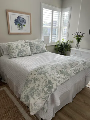 a bedroom with a large bed and a large window