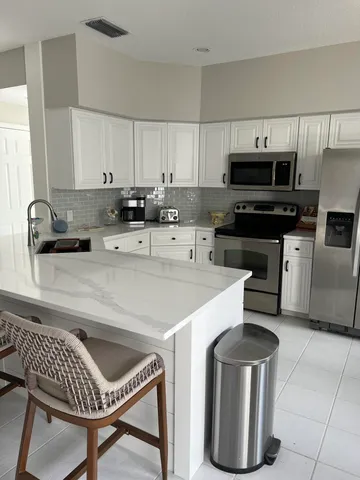 a kitchen with a stove a sink and a microwave