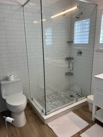 a bathroom with a toilet and a shower