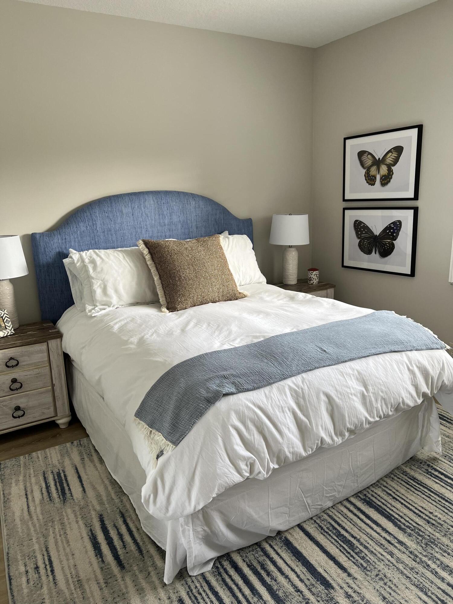 3028 Windward Way Jupiter, FL 33477 - Photo 22 of 48 a bedroom with a bed and painting on the wall