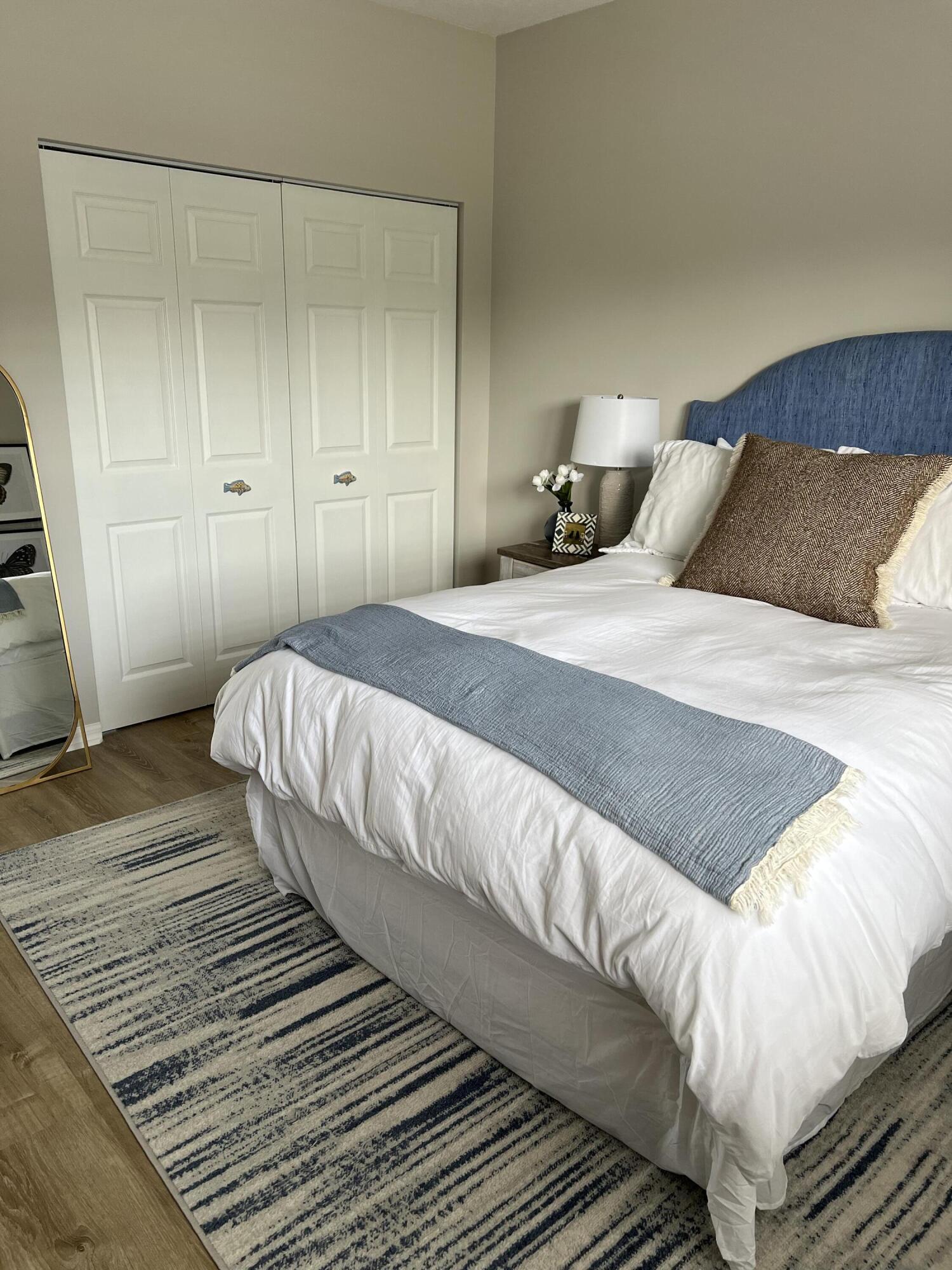 3028 Windward Way Jupiter, FL 33477 - Photo 23 of 48 a bedroom with a bed and wooden floor