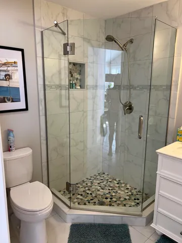 a bathroom with a shower and toilet