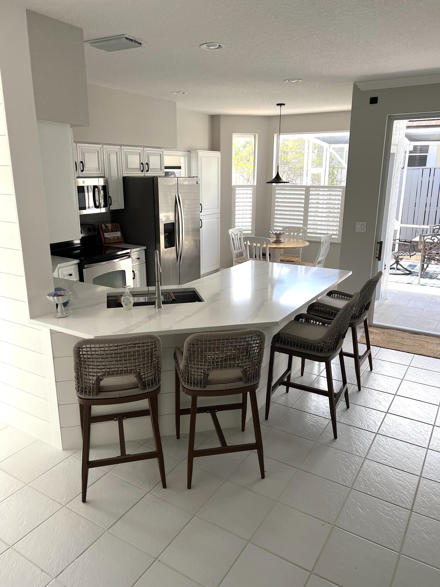 3028 Windward Way Jupiter, FL 33477 - Photo 3 of 48 a dining room with furniture and window
