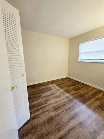 a view of a room with wooden floor