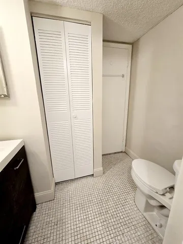 a bathroom with a toilet a sink and bathtub