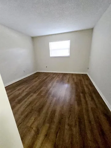 a view of outdoor space with wooden floor and windows