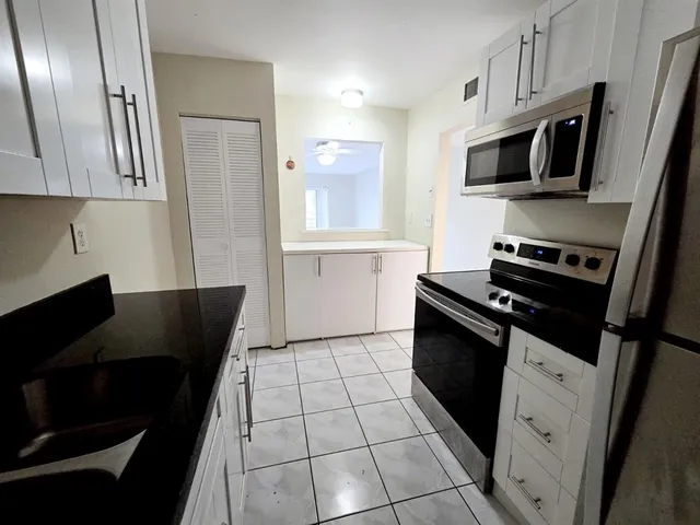 a kitchen with cabinets and steel stainless steel appliances