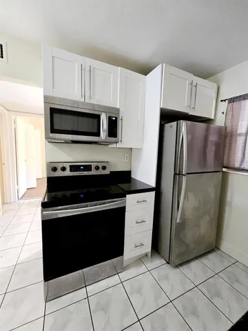 a kitchen with a sink stove and microwave