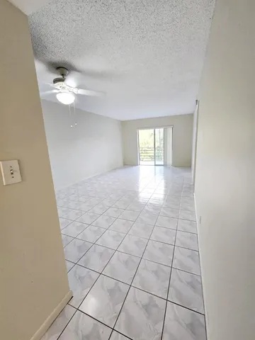 a view of wooden floor and windows in a room