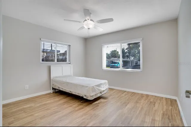 a bedroom with a bed and a window