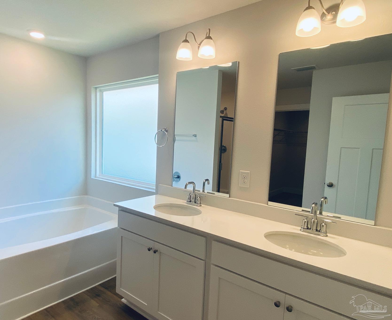 3021 Serviceberry Road Cantonment, FL 32533 - Photo 15 of 21 a bathroom with a tub sink and mirror