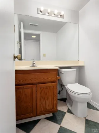 a bathroom with a sink a toilet and mirror
