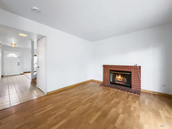 a view of an empty room with a fireplace