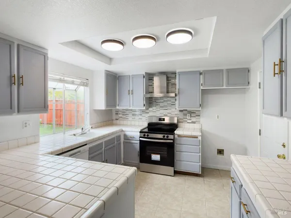 a kitchen with a sink appliances and cabinets