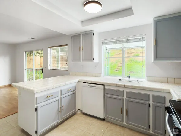 a kitchen with a sink stove and cabinets