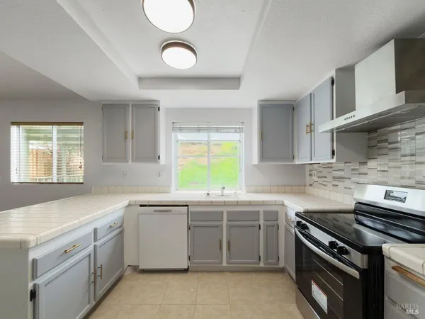a kitchen that has a sink and a stove in it