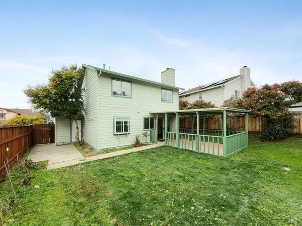 a view of a house with a yard and sitting area