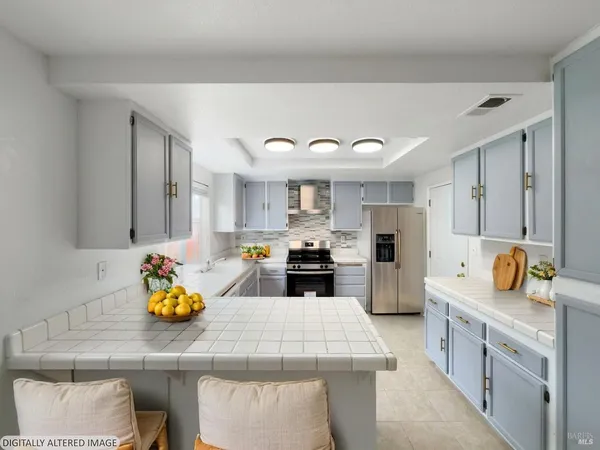 a kitchen with a sink appliances and cabinets