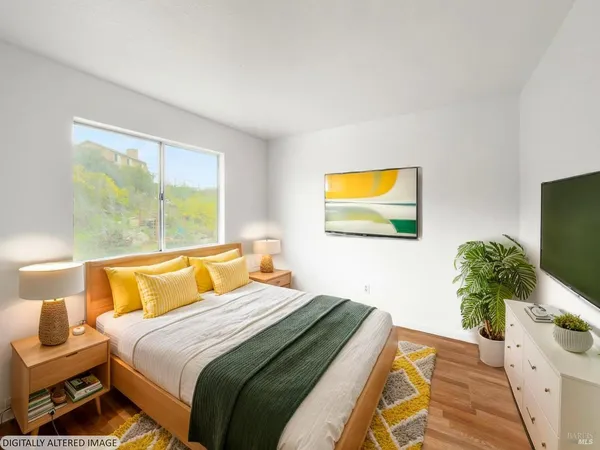 a bedroom with a bed and a potted plant