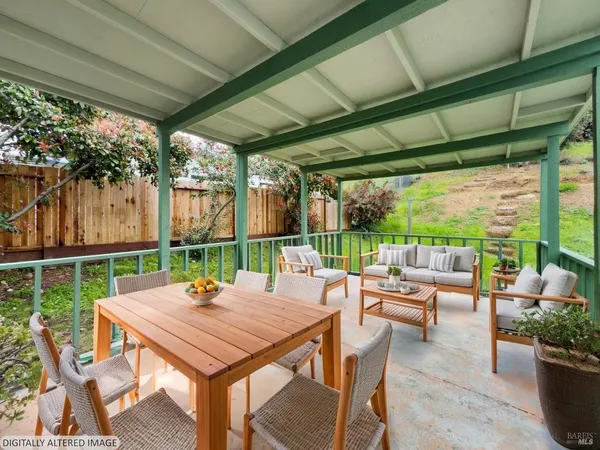 a view of a patio with a table chairs and a backyard