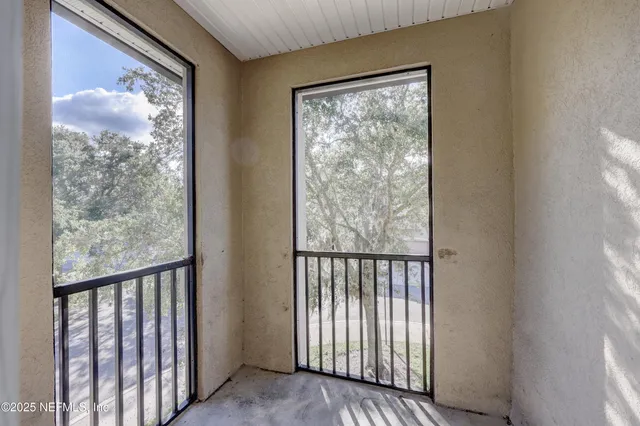 a view of a porch with wooden floor and a window