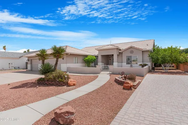 a front view of a house with outdoor seating