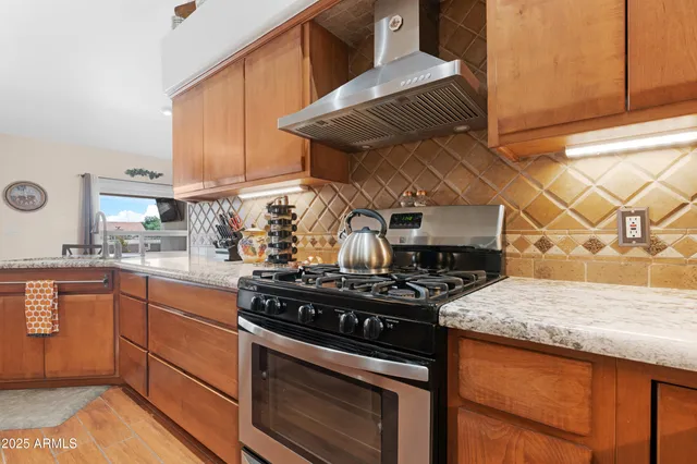 a kitchen with stainless steel appliances granite countertop a stove and a sink