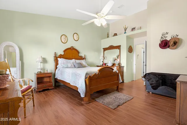 a bedroom with a bed and wooden floor