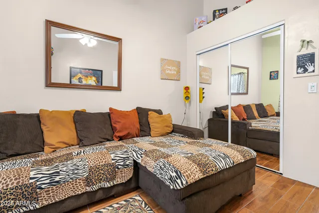 a bedroom with a large bed and a painting on the wall