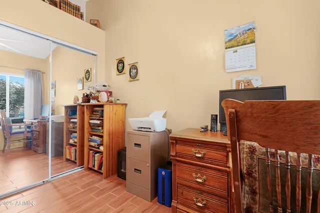 a bedroom with a dresser and book shelf